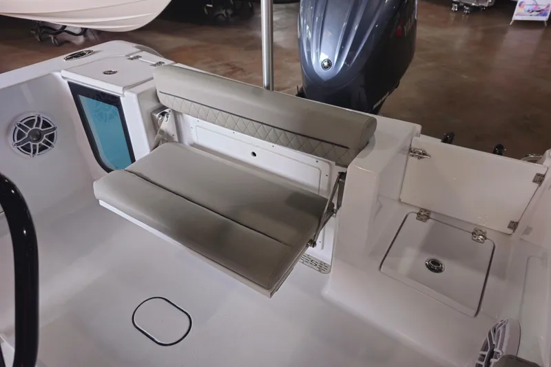 Slide: The Image of 2025 Sportsman Open 232 Center Console boat interior with cushioned seating and storage. - 2