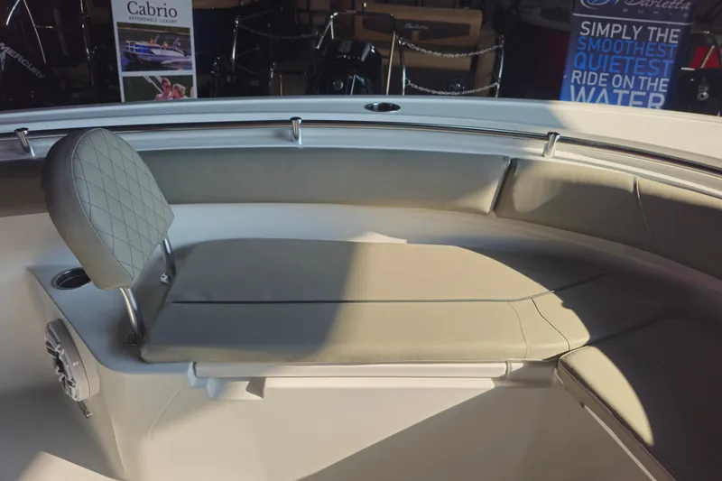 Slide: The Image of 2025 Sportsman Open 232 Center Console boat interior with cushioned seating and backrest. - 7