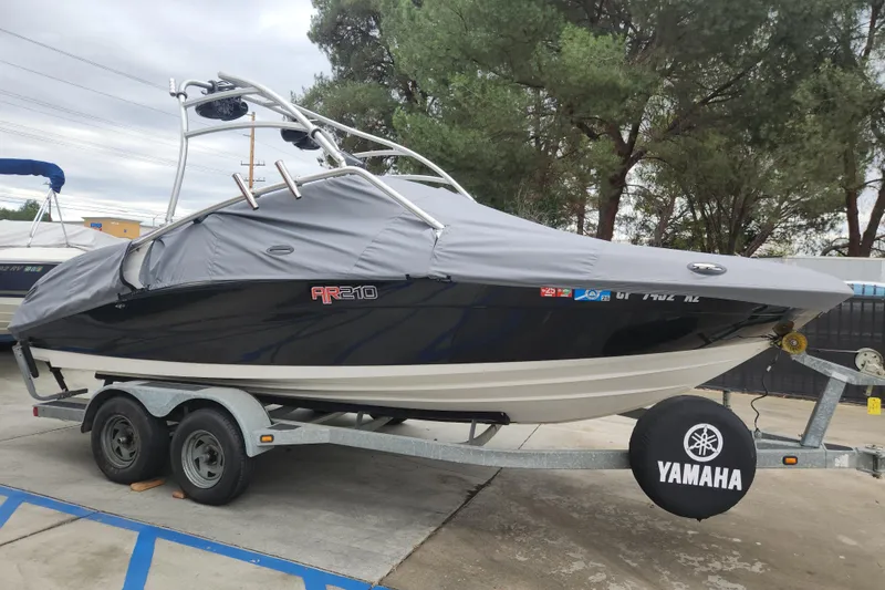 Slide: The Image of 2007 Yamaha AR210 boat on trailer, covered, parked outdoors. - 0