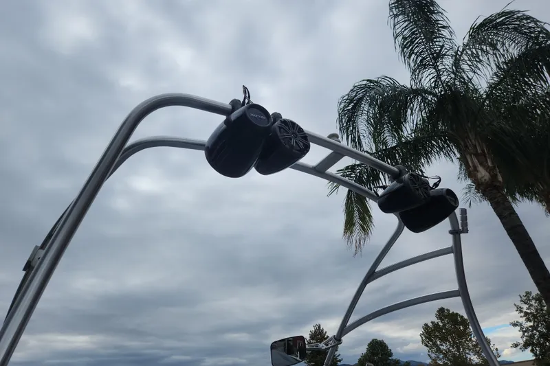 Slide: The Image of 2007 Yamaha AR210 boat speakers on a wakeboard tower against a cloudy sky. - 1