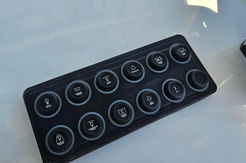 Slide: The Image of Control panel of 2025 Sportsman Heritage 231 Center Console boat with labeled buttons. - 12