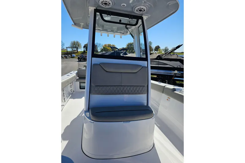 Slide: The Image of 2025 Sportsman Heritage 231 Center Console boat interior with seating and console view. - 14