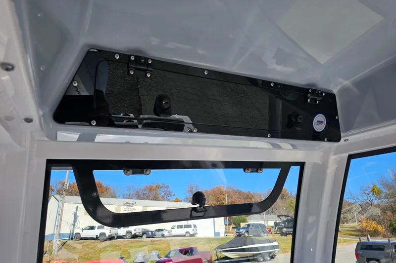 Slide: The Image of 2025 Sportsman Heritage 231 Center Console interior view with windshield and overhead compartment. - 18