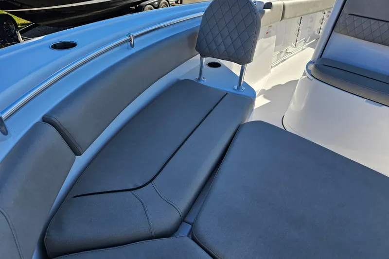 Slide: The Image of 2025 Sportsman Heritage 231 Center Console boat interior with cushioned seating and sleek design. - 22