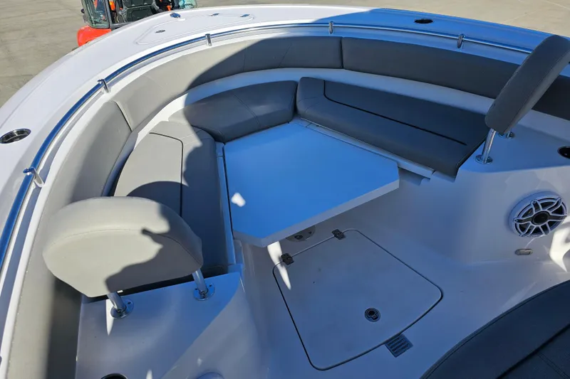 Slide: The Image of 2025 Sportsman Heritage 231 Center Console boat interior with seating and table. - 23