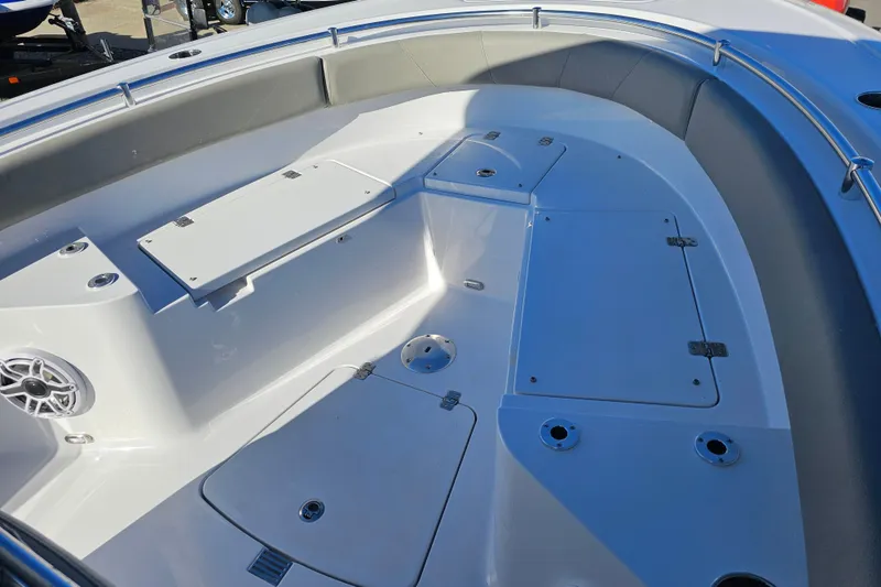 Slide: The Image of 2025 Sportsman Heritage 231 Center Console boat interior with storage compartments and seating. - 25
