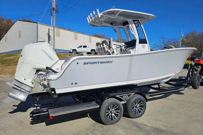 Slide: The Image of 2025 Sportsman Heritage 231 Center Console boat on trailer, featuring Mercury outboard engine. - 3