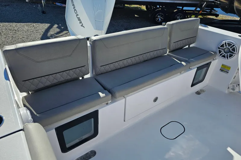 Slide: The Image of 2025 Sportsman Heritage 231 Center Console boat seating area with gray cushions and storage compartments. - 31