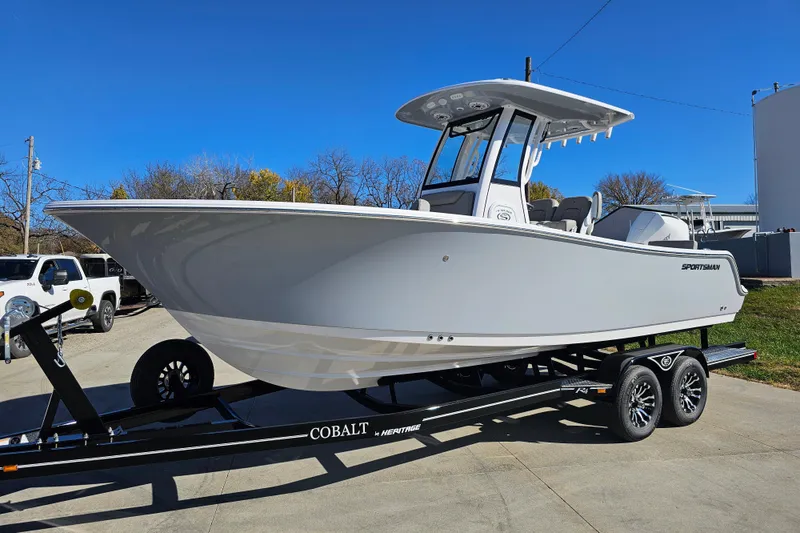 Slide: The Image of 2025 Sportsman Heritage 231 Center Console boat on trailer, parked outdoors. - 4