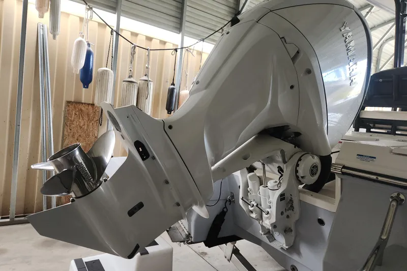 Slide: The Image of 2024 Robalo 246 Cayman boat with Yamaha outboard motor in a storage area. - 11