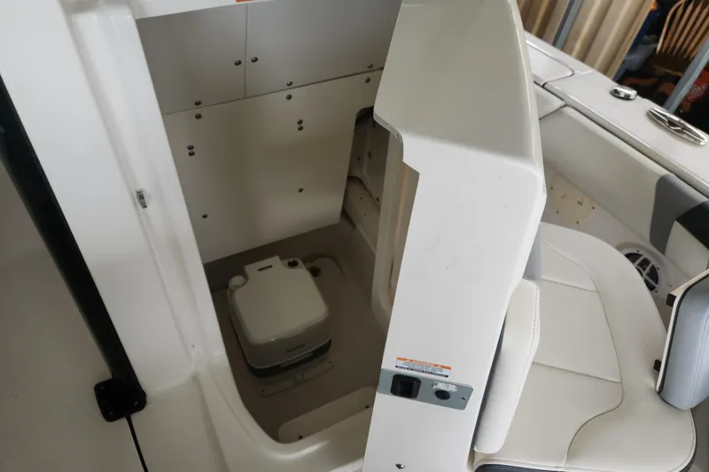 Slide: The Image of 2024 Robalo 246 Cayman boat interior with compact marine toilet. - 4