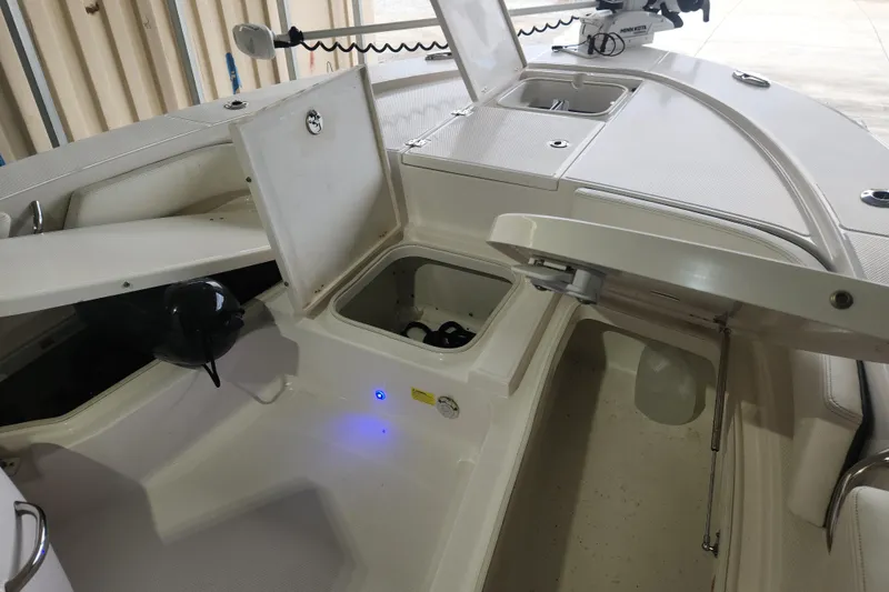 Slide: The Image of 2024 Robalo 246 Cayman boat interior with open storage compartments and modern features. - 8