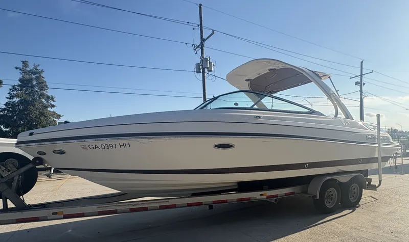 Slide: The Image of 2013 Rinker Captiva 276 boat on trailer under clear sky. - 2