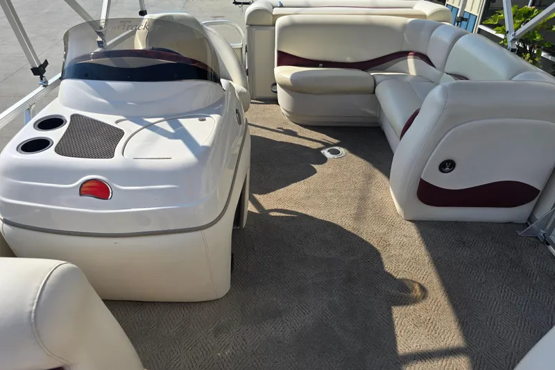 Slide: The Image of 2011 Sun Tracker Party Barge 21 Signature Series interior with plush seating and helm. - 13
