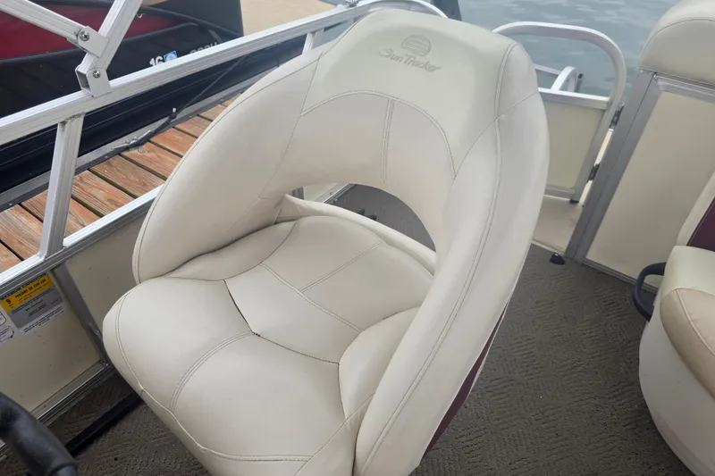Slide: The Image of 2011 Sun Tracker Party Barge 21 Signature Series boat seat, white upholstery, dockside view. - 17