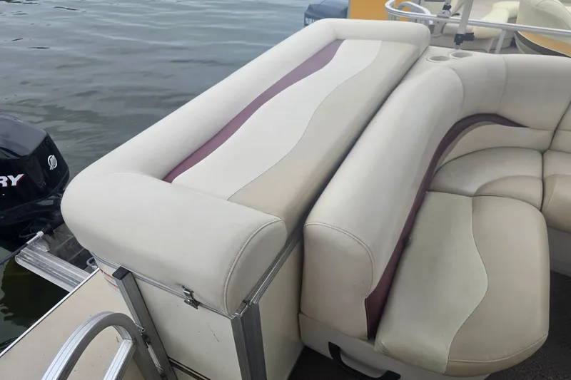 Slide: The Image of 2011 Sun Tracker Party Barge 21 Signature Series with beige and maroon seating on water. - 19