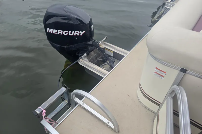 Slide: The Image of 2011 Sun Tracker Party Barge 21 with Mercury outboard motor on water. - 20