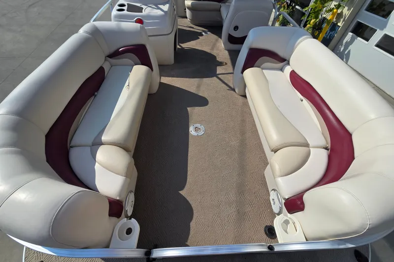 Slide: The Image of 2011 Sun Tracker Party Barge 21 Signature Series interior with plush seating and cup holders. - 9