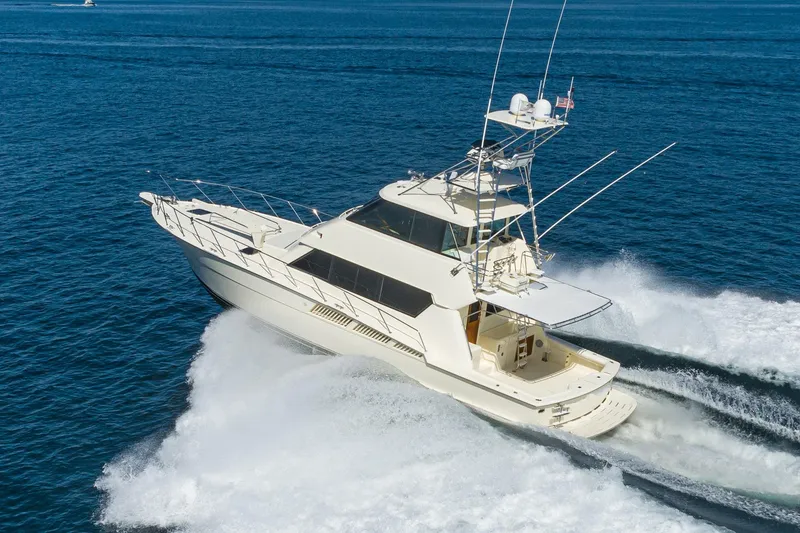 The Image of 1991 Hatteras 58 Convertible yacht cruising on open water. - 0