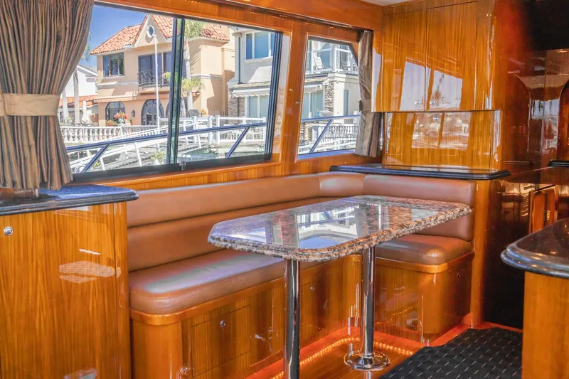 Slide: The Image of Interior of 1991 Hatteras 58 Convertible yacht with plush seating and waterfront view. - 10