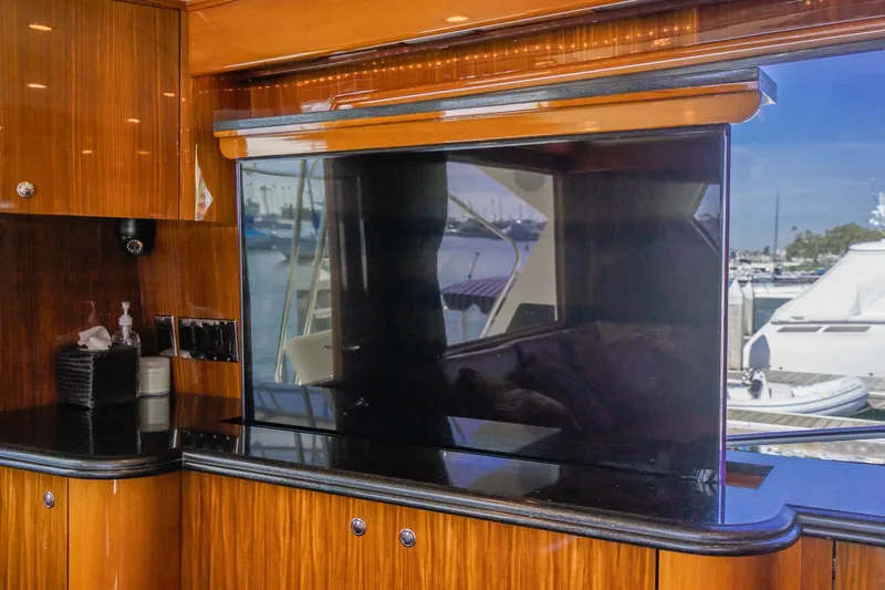 Slide: The Image of Luxurious interior of 1991 Hatteras 58 Convertible yacht with elegant wood finishes and modern decor. - 11