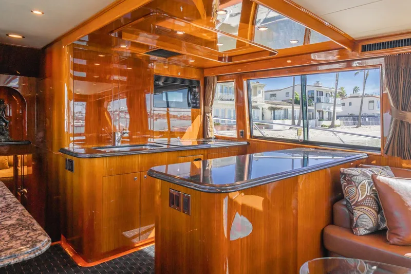 Slide: The Image of Luxurious interior of 1991 Hatteras 58 Convertible yacht with polished wood finishes. - 12
