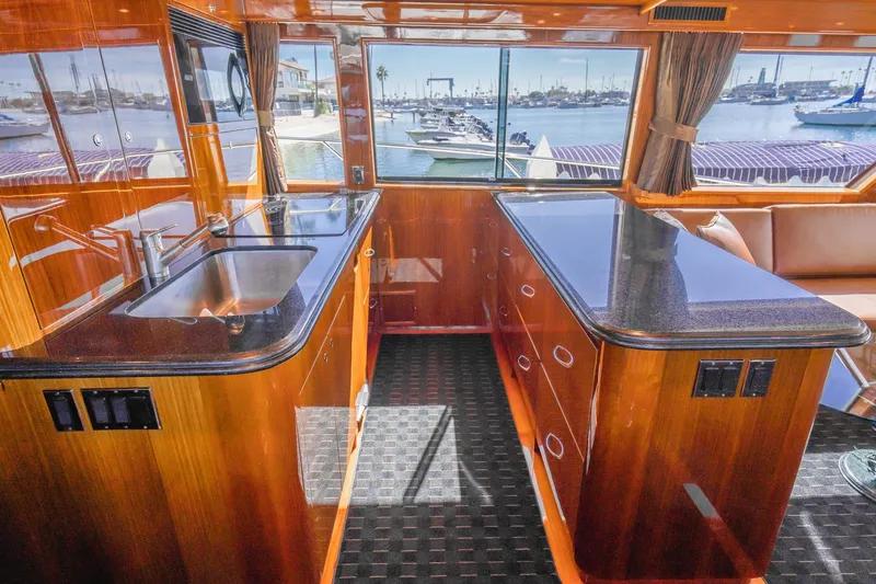Slide: The Image of Luxurious interior of 1991 Hatteras 58 Convertible yacht with leather seating and wooden accents. - 13