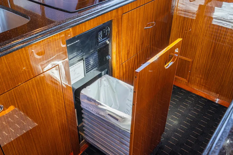 Slide: The Image of Luxurious interior of 1991 Hatteras 58 Convertible yacht with elegant wood finishes and modern decor. - 15