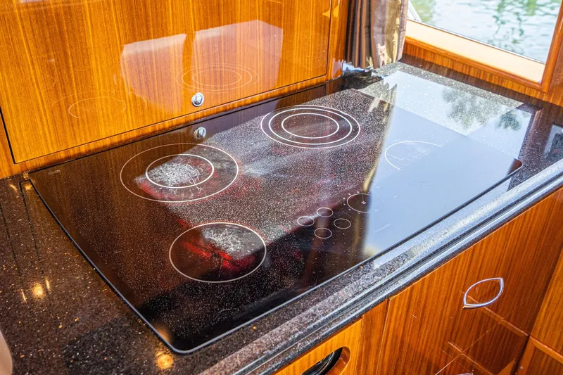 Slide: The Image of Luxurious interior of 1991 Hatteras 58 Convertible yacht with polished wood and modern amenities. - 17