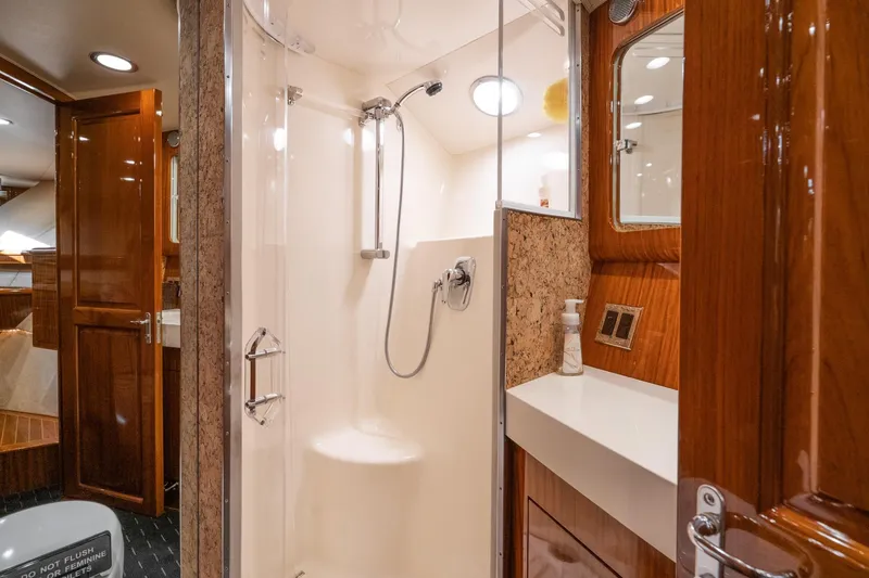 Slide: The Image of Luxurious interior of 1991 Hatteras 58 Convertible yacht with elegant wood finishes and marina view. - 22