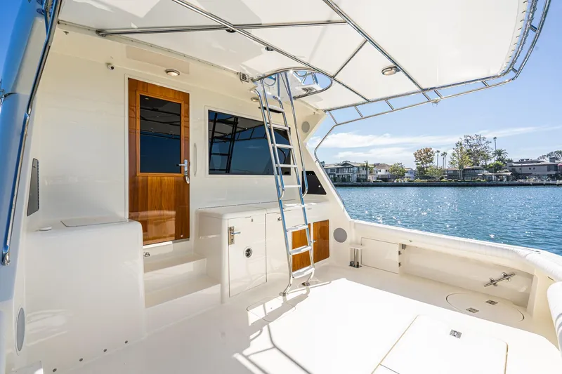 Slide: The Image of Luxurious 1991 Hatteras 58 Convertible yacht interior with wood paneling and elegant decor. - 30
