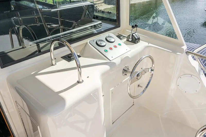 Slide: The Image of Helm of 1991 Hatteras 58 Convertible yacht with steering wheel and control panel. - 50