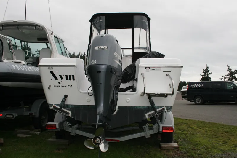Slide: The Image of 2013 Pro-Line 20 Express boat with Yamaha 200 engine, parked on grass. - 2