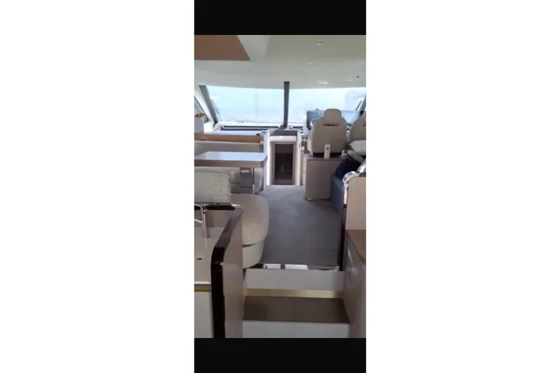 Slide: The Image of 2020 Azimut 55 yacht docked under a covered marina, with a person performing maintenance. - 1