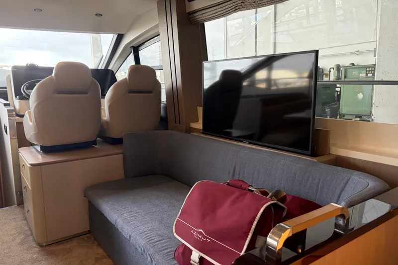 Slide: The Image of Interior of 2020 Azimut 55 yacht with seating, TV, and helm chairs. - 11