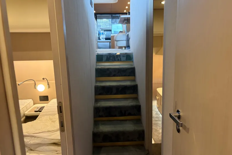Slide: The Image of Interior of 2020 Azimut 55 yacht, featuring stairs and cozy cabin spaces. - 12