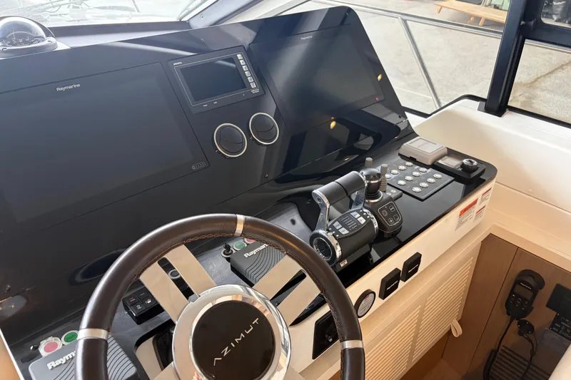 Slide: The Image of Cockpit of 2020 Azimut 55 yacht with advanced navigation controls and steering wheel. - 13