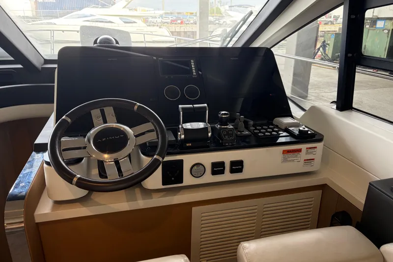 Slide: The Image of Cockpit of 2020 Azimut 55 yacht with steering wheel and control panel. - 15