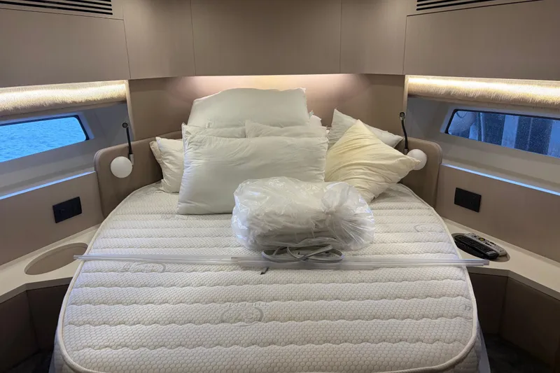 Slide: The Image of Luxurious Azimut 55 yacht bedroom interior, 2020 model, featuring a cozy bed with pillows. - 20