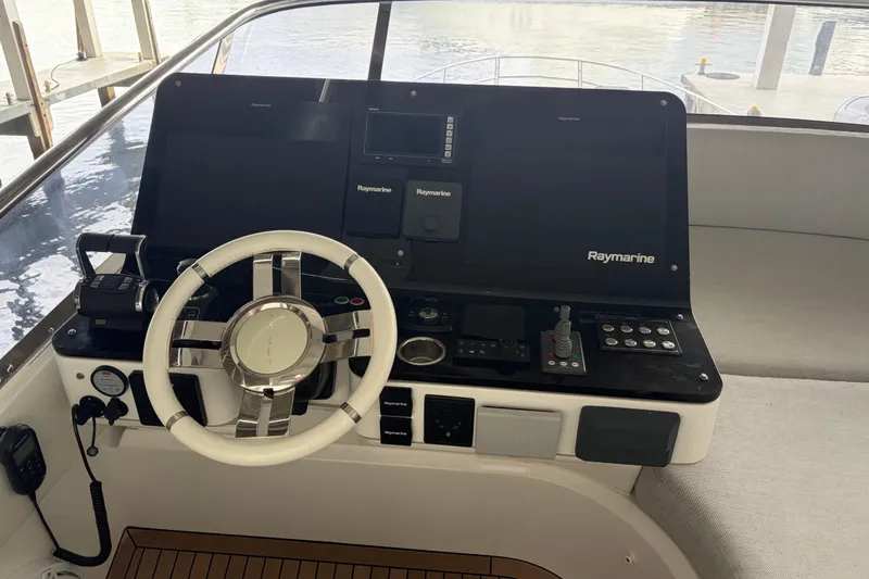 Slide: The Image of Helm of 2020 Azimut 55 yacht with Raymarine navigation system and modern controls. - 24