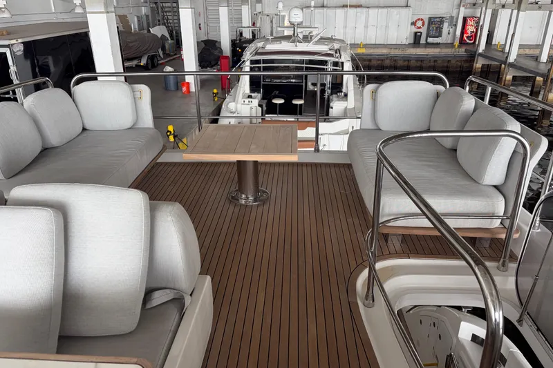 Slide: The Image of Luxurious 2020 Azimut 55 yacht interior with elegant seating and wooden deck. - 25