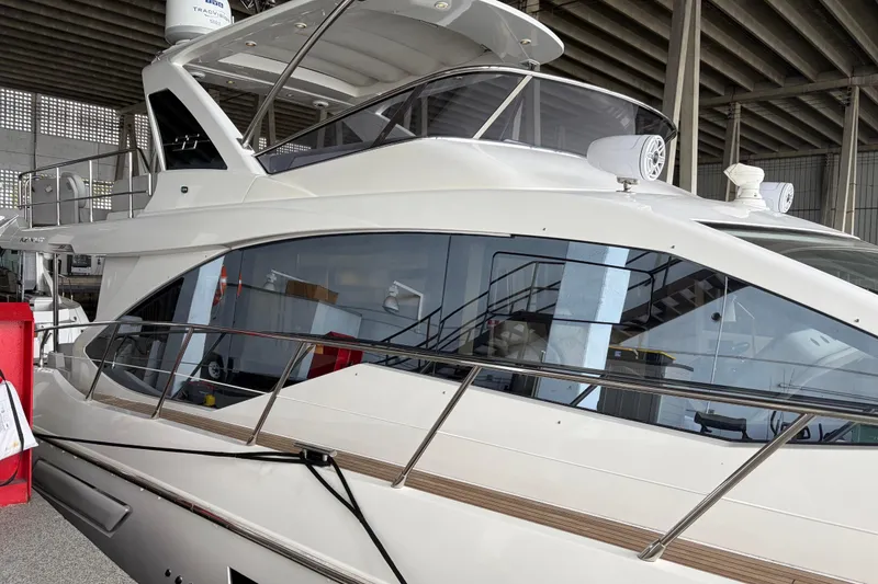 Slide: The Image of 2020 Azimut 55 yacht in a marina, showcasing sleek design and modern features. - 3