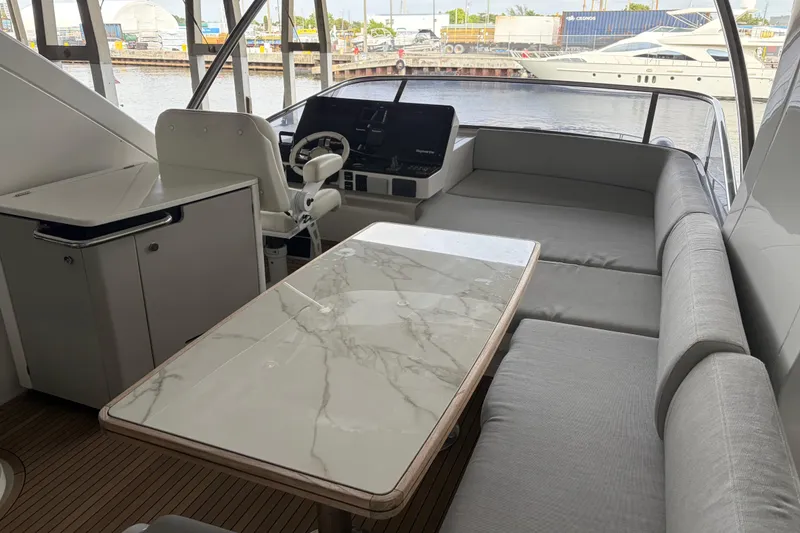 Slide: The Image of Luxurious 2020 Azimut 55 yacht interior with marble table and plush seating. - 6