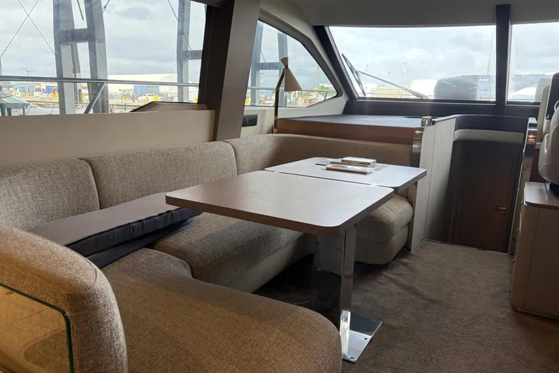 Slide: The Image of Luxurious interior of 2020 Azimut 55 yacht with elegant seating and table. - 9