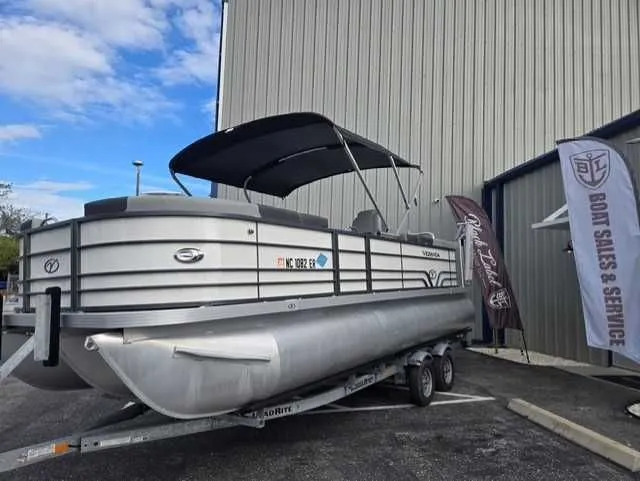 Slide: The Image of 2020 Veranda VTX22RC pontoon boat on trailer, displayed at boat sales and service center. - 11