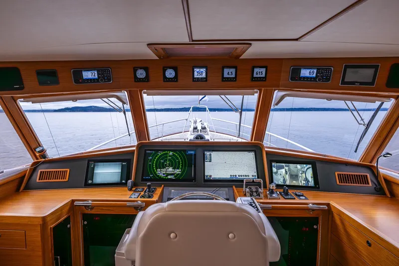 Slide: The Image of Pilothouse of 2026 Fleming 55 yacht with advanced navigation systems and panoramic sea view. - 31