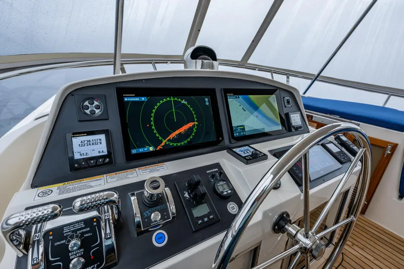 Slide: The Image of Pilothouse of 2026 Fleming 55 yacht with advanced navigation systems and steering wheel. - 40