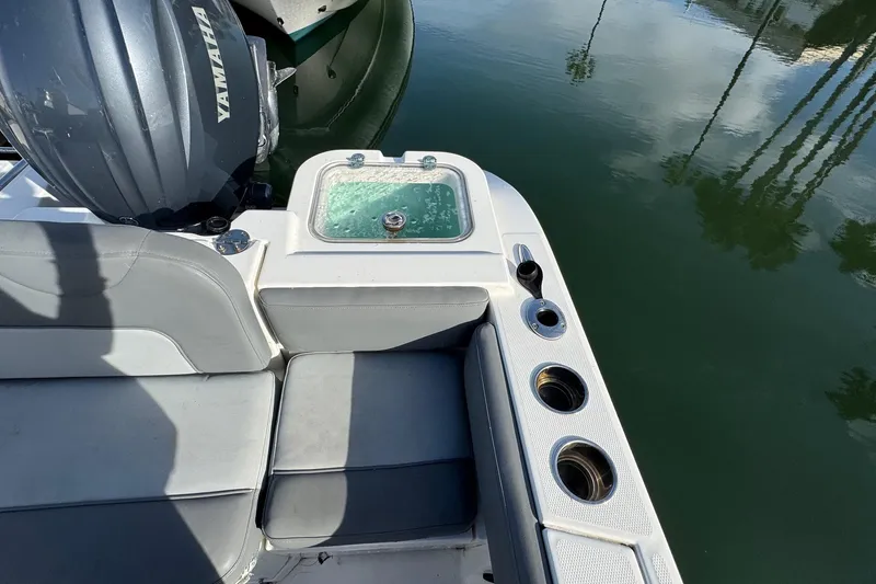 Slide: The Image of 2023 NauticStar 242L Offshore boat interior with helm, seating, and control panel. - 15