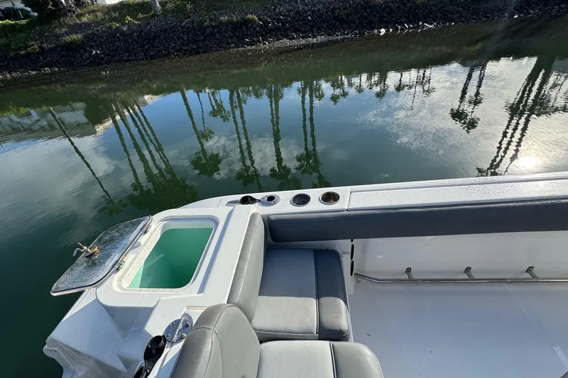 Slide: The Image of 2023 NauticStar 242L Offshore boat console with steering wheel and control panel. - 16