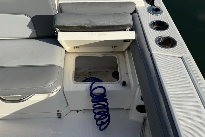 Slide: The Image of 2023 NauticStar 242L Offshore boat dashboard with controls and switches. - 17